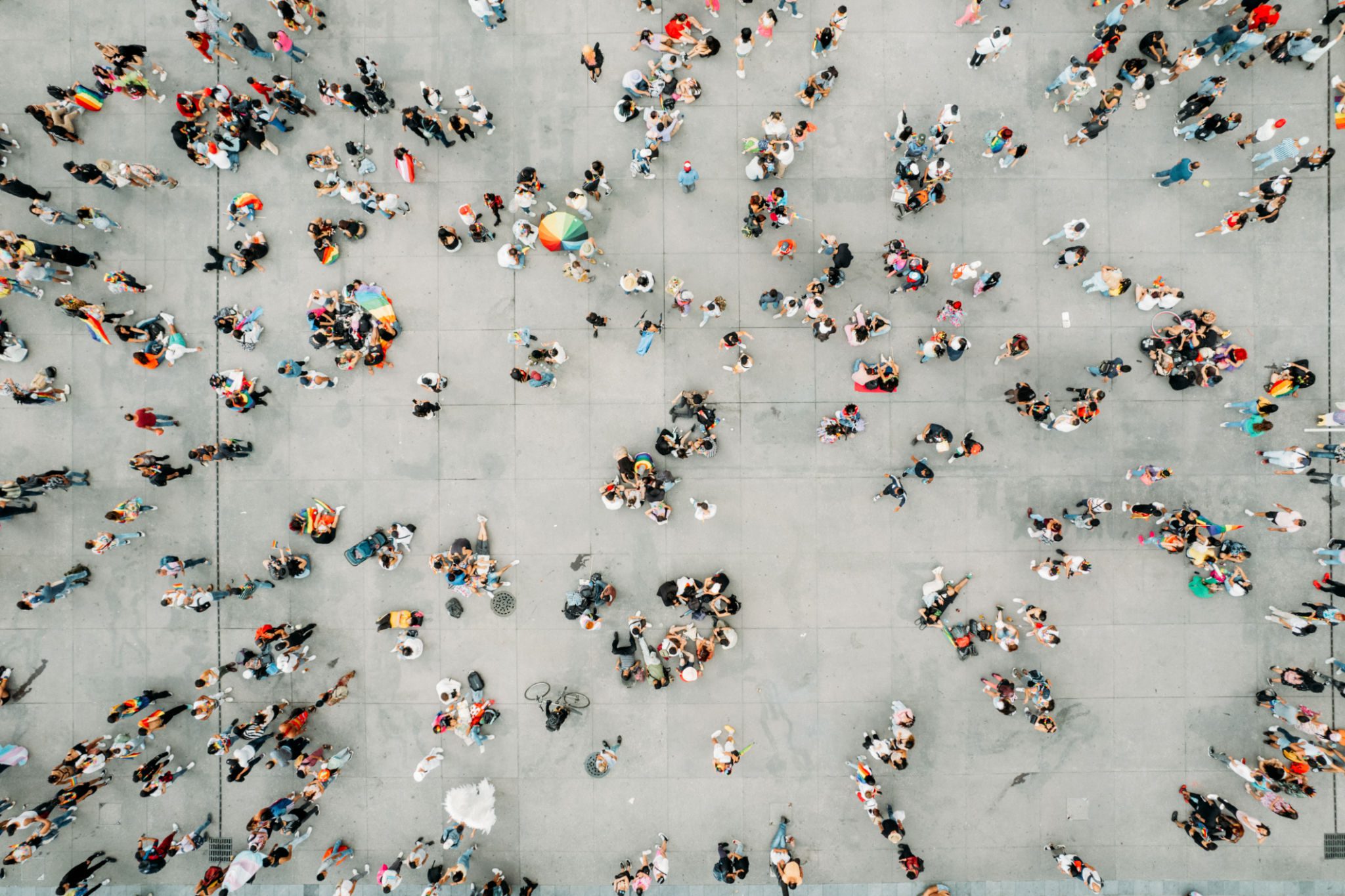 Many individuals walking on a plaza